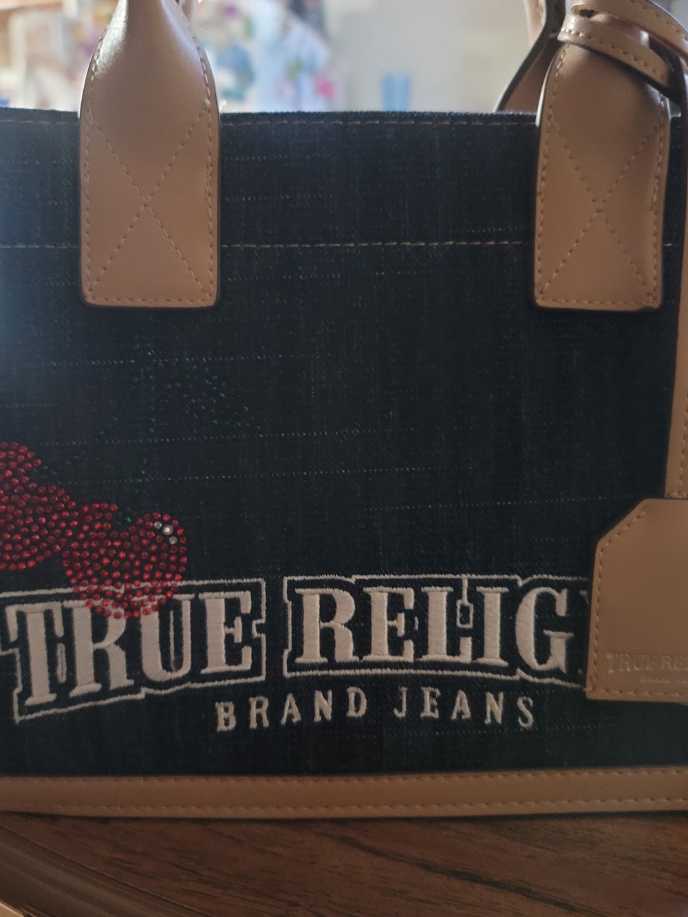 True Religion Black Denim Crossbody Tote with Tan Trim and Red Cherry Accent